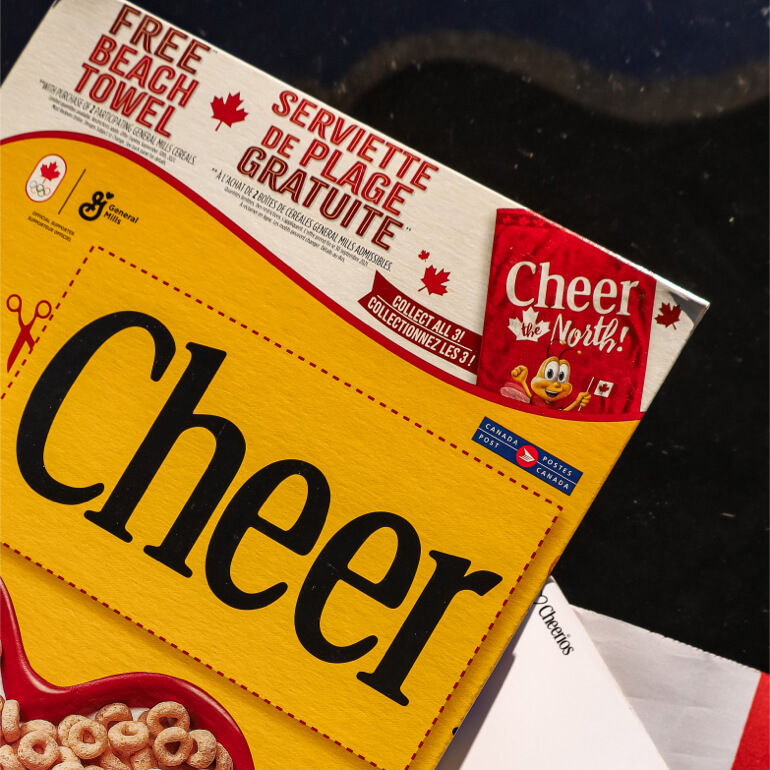 Close up image of a Cheerios box and the Cheer Card