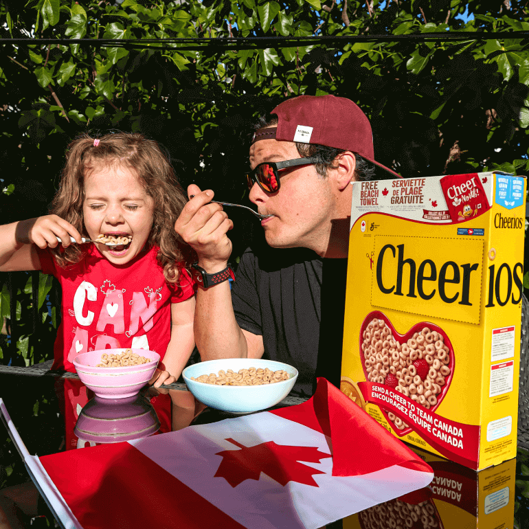 Dad and daughter eating a bowl of Cheerios